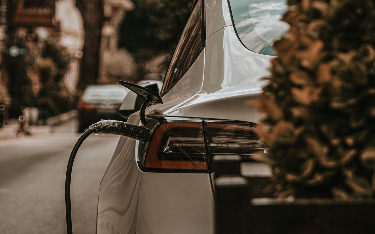 An electric vehicle charging at a charge point